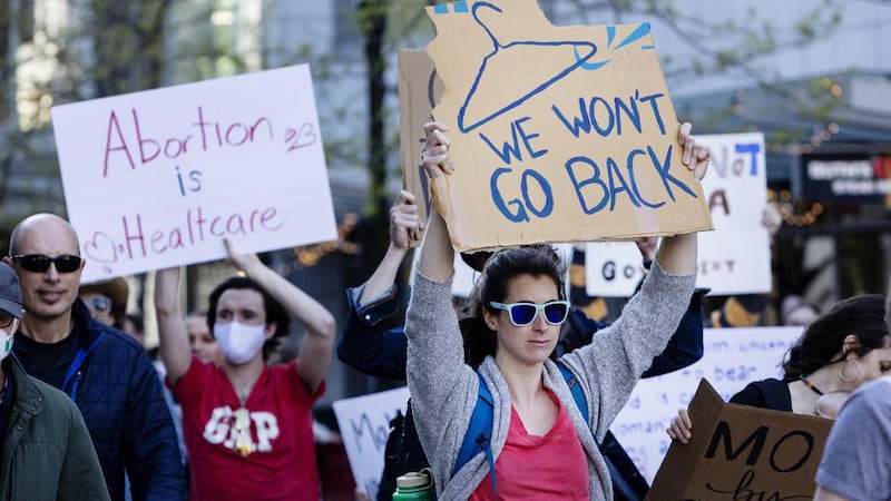 People march through 8th Street in downtown Boise, Idaho, on May 3, 2022.