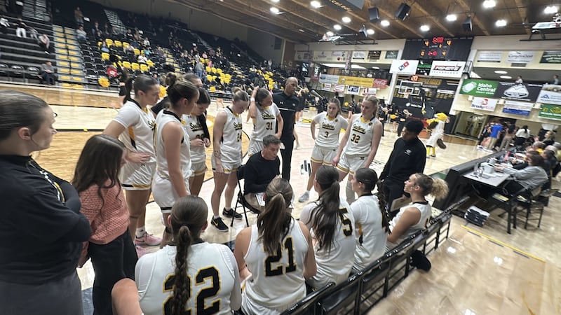 CSI head coach Randy Rogers talks with his team during a timeout during the game against Salt...