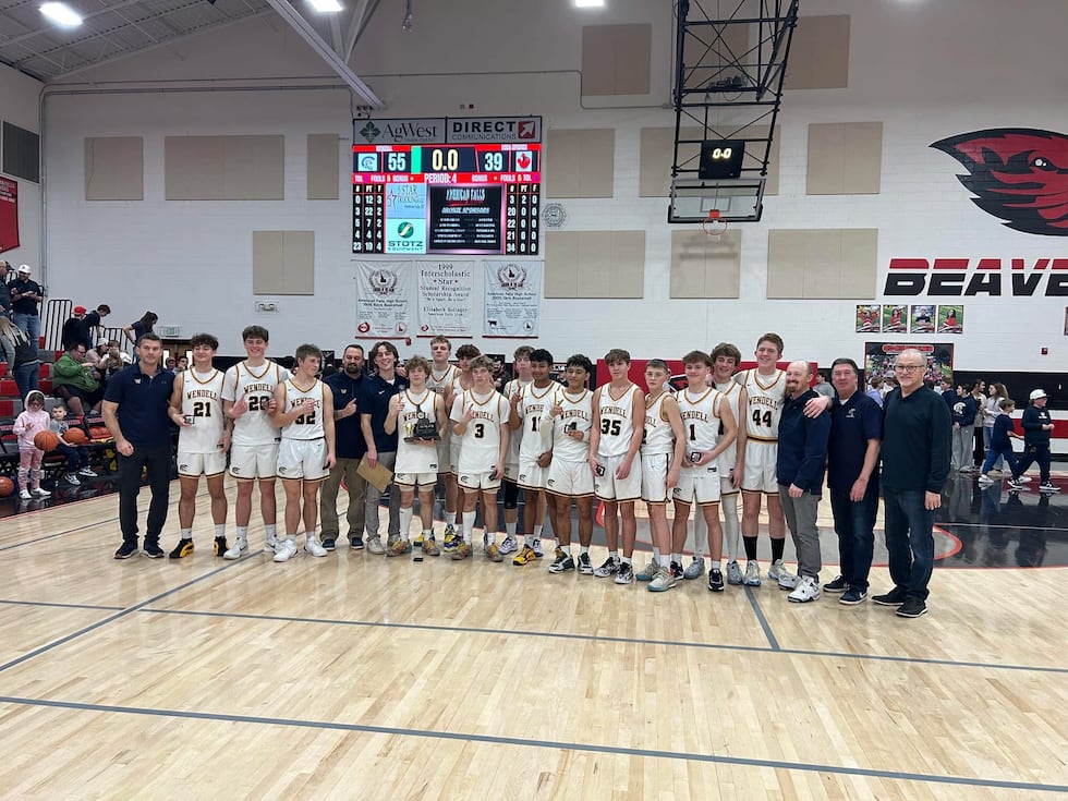 The Wendell boys basketball team celebrates after beating Soda Springs in the 3A SEIC...